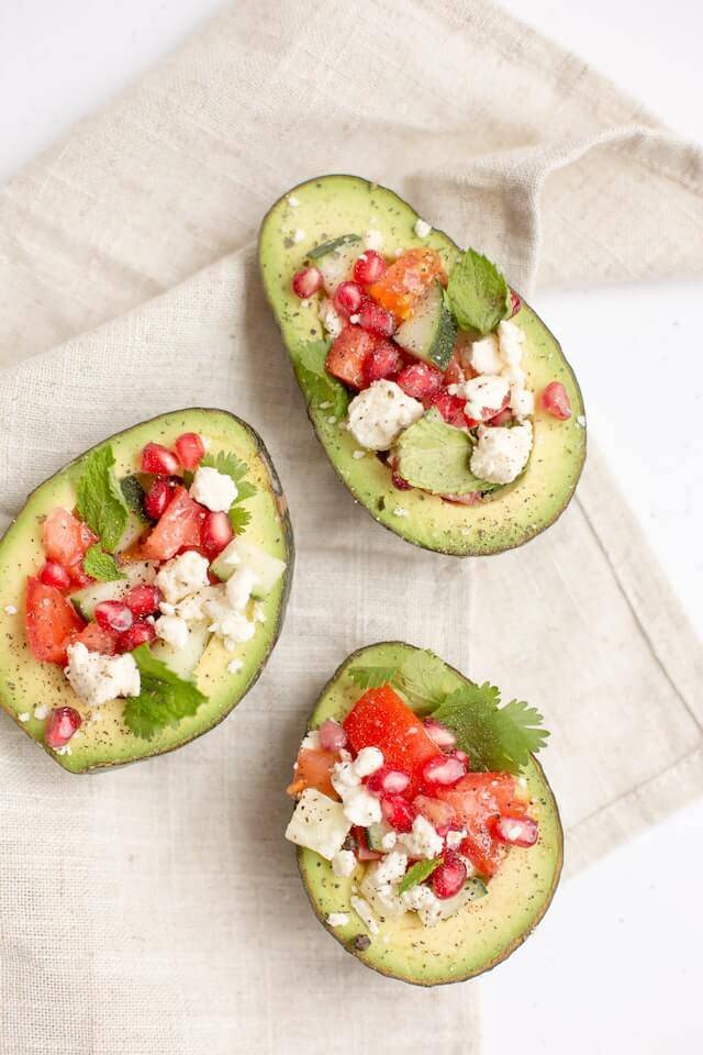 Avocado with cheese and fruits. A great keto breakfast option